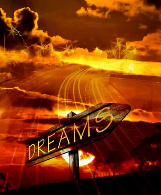 'Dreams' sign in golden sky with clouds