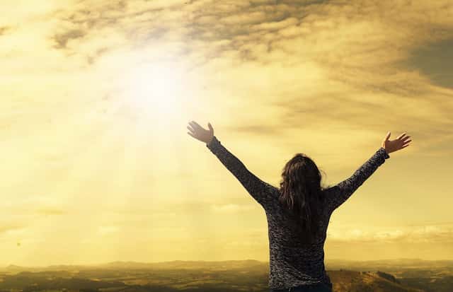 Woman rejoicing in the Radiant Sunlight Surrendering to Higher Guidance