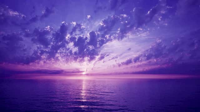 Sunlight Shining through Violet Hue Clouds and Ocean