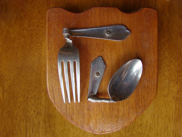 Bent Spoon and Fork on a Plaque